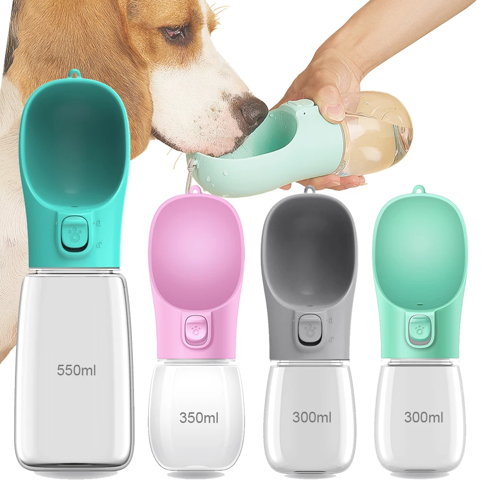 White portable dog water bottle with spout held beside a walking dog